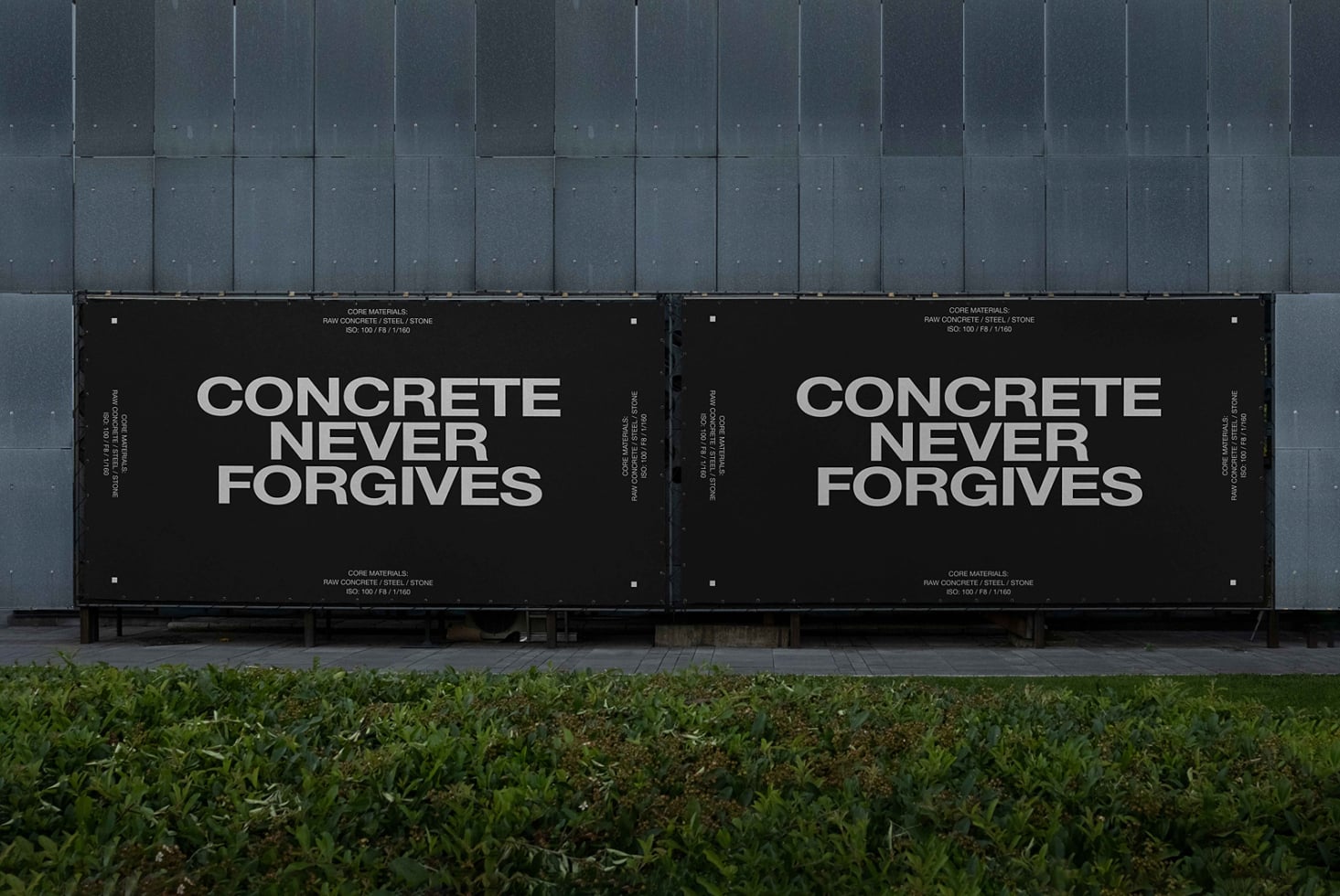 Two black outdoor billboard panels against metal wall with white typography message