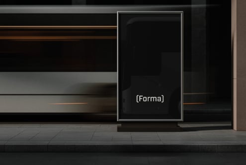 Dark vertical storefront display case mounted on concrete street facade
