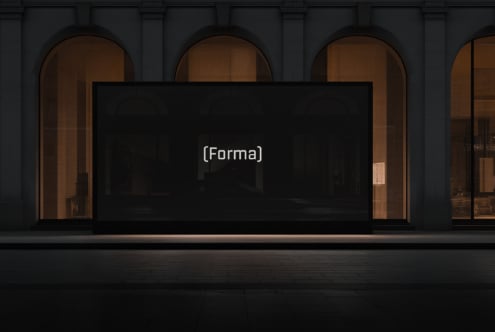 Storefront window mockup with dark screen on classical building facade