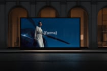 Woman in white robe leaning on car displayed on storefront window screen