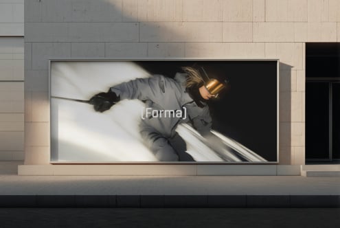 Large storefront billboard showing woman in gray jacket, gold visor, Forma branding