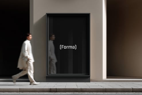 Dark framed digital display mounted on gallery wall showing text overlay