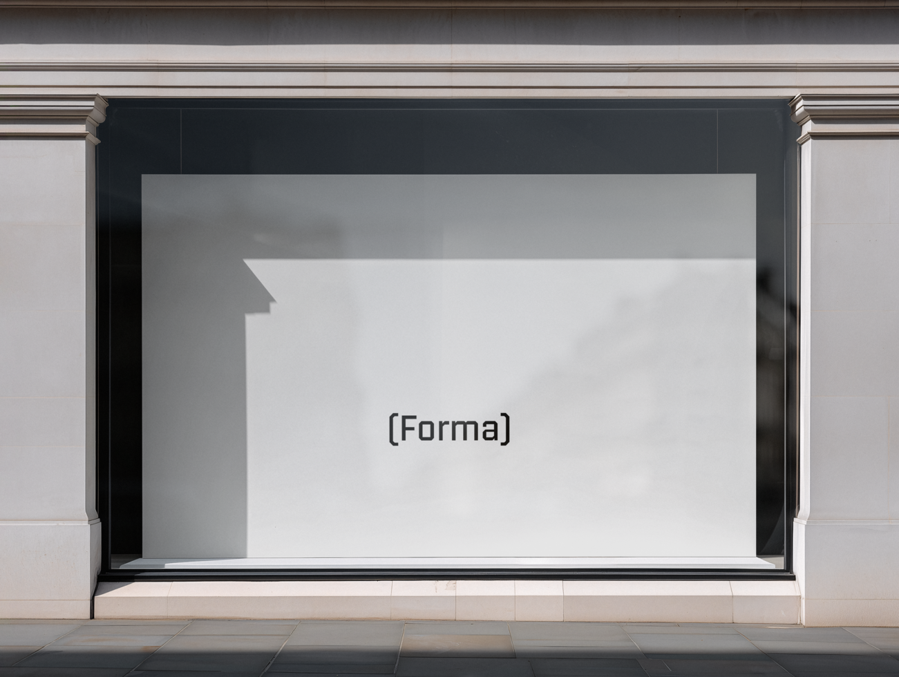 Empty storefront window with black frame on cream stone facade, ready for branding
