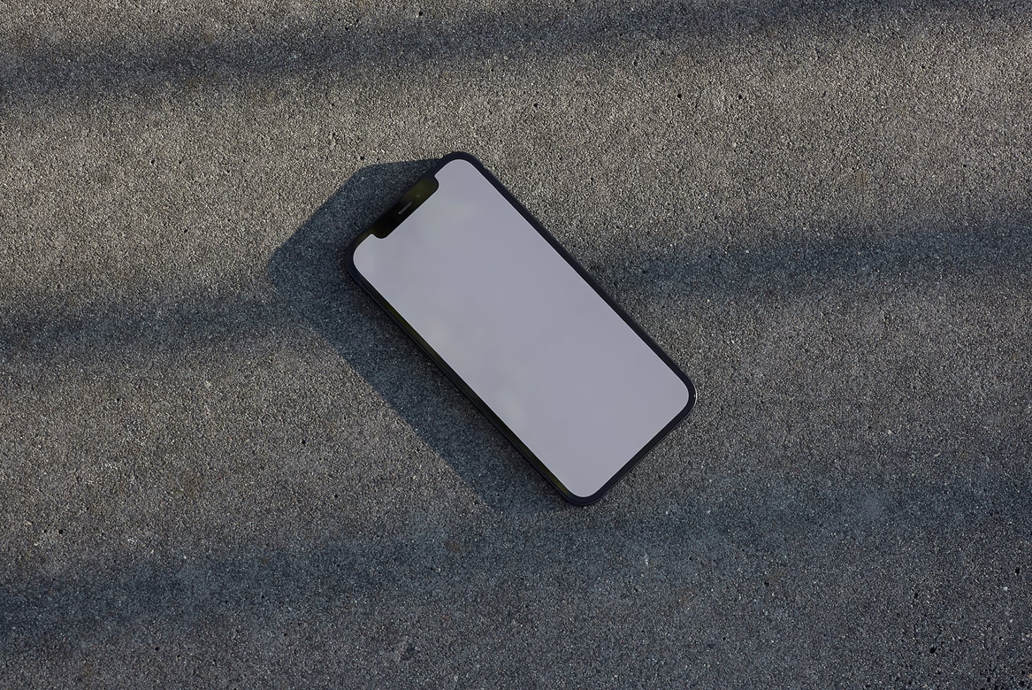 Smartphone mockup on concrete background for showcasing designs shadows enhance realism ideal for designers templates digital assets realistic mockups