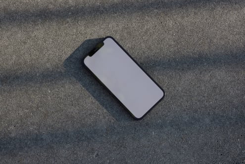 Smartphone mockup on concrete background for showcasing designs shadows enhance realism ideal for designers templates digital assets realistic mockups