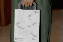 White paper shopping bag mockup held by person in hands front view