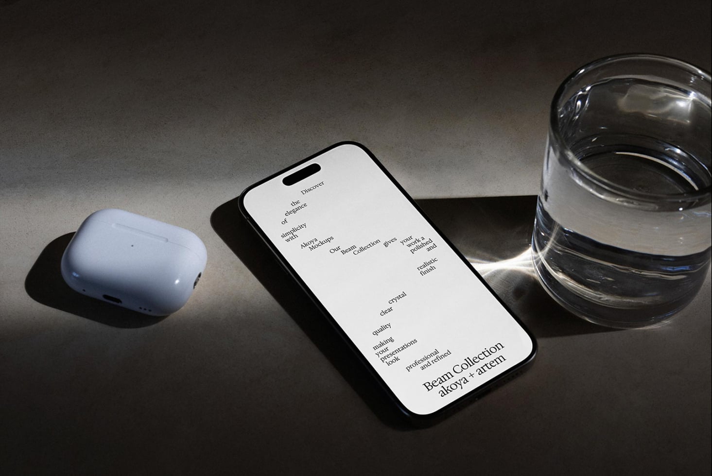 iPhone mockup displaying minimalist text layout next to white earbuds, glass of water