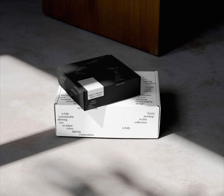 Open white shipping box with black product box inside, text on sides visible