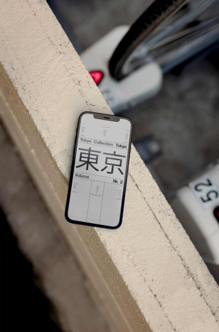 Smartphone mockup on concrete ledge showing Tokyo Collection volume layout