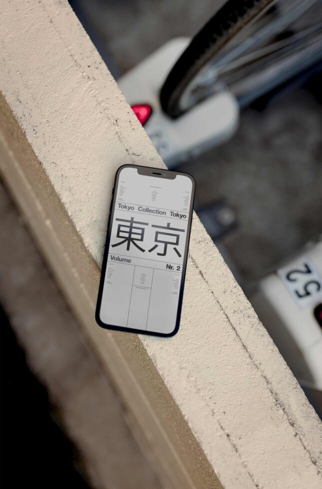 Smartphone mockup on concrete ledge showing Tokyo Collection volume layout