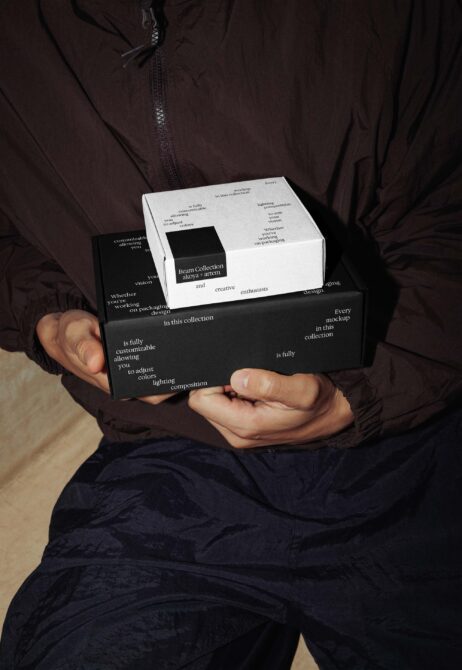 Hands holding black white nested box set with branded insert