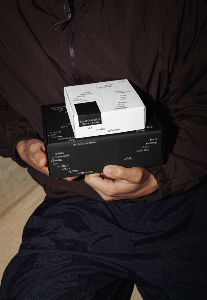 Hands holding black white nested box set with branded insert