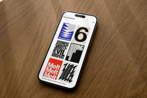 iPhone mockup displaying Harry Richards portfolio with bold typography, colorful logos, gradient text on wooden surface