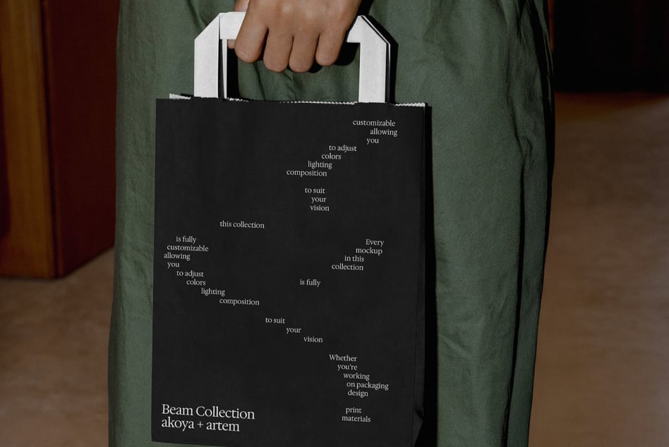 Black paper shopping bag mockup held by person in hands front view