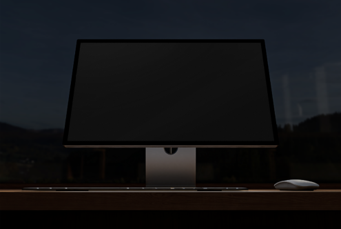 Computer monitor mockup with keyboard and mouse on dark wood desk background ideal for designers showcases UX/UI, minimalist workspace template