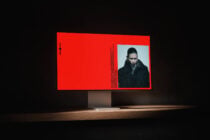 Bright red billboard mockup showing fashion portrait with geometric text layout