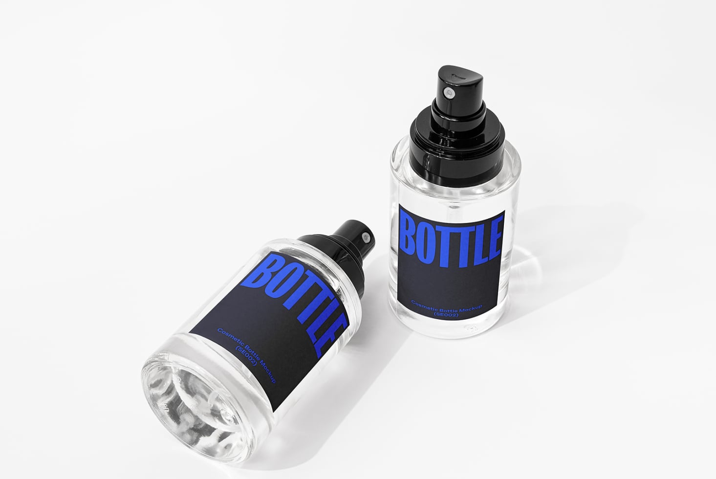 Two clear spray bottles with black pump tops, dark label with blue BOTTLE text