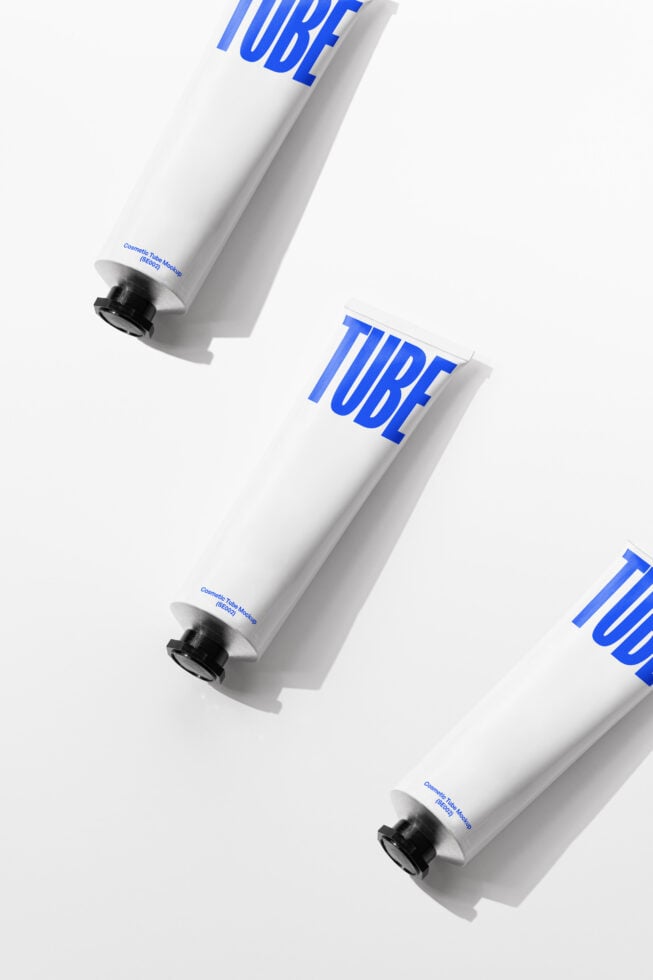 Three white cosmetic tubes arranged diagonally with blue TUBE branding