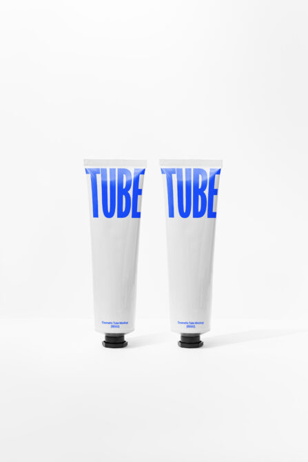 Pair of white cosmetic tubes with bright blue TUBE text labels printed
