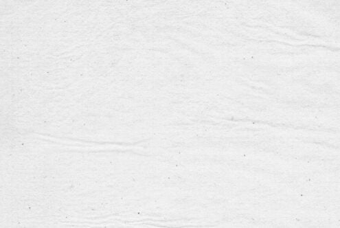 Close-up texture of light gray concrete or stone surface with subtle grain
