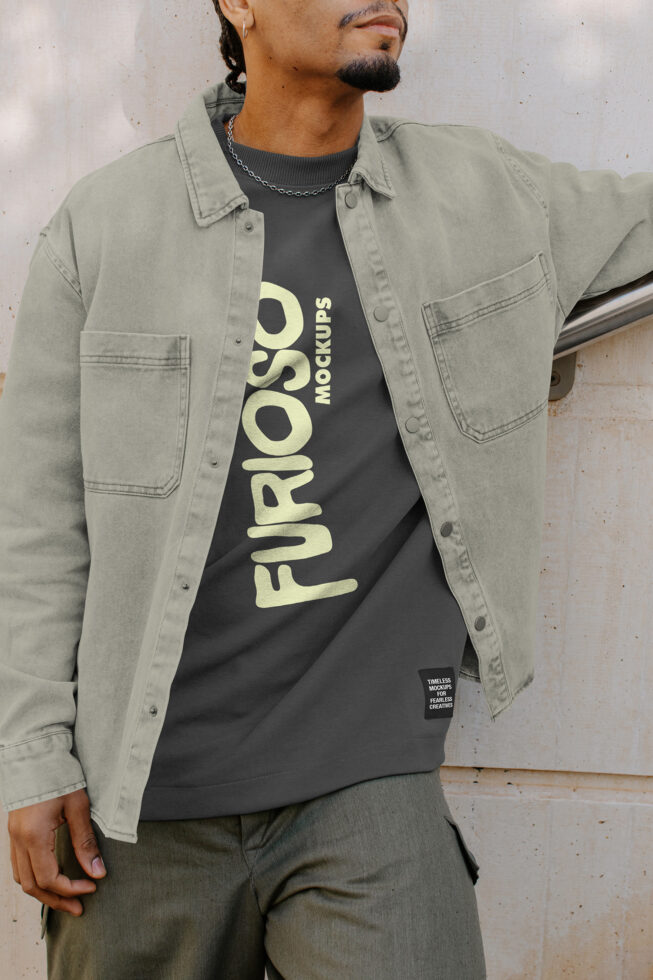 Person wearing beige overshirt over black tee with cream Furioso text printed vertically