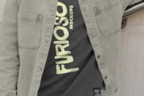 Cropped view of beige jacket open over black shirt with cream Furioso text down center