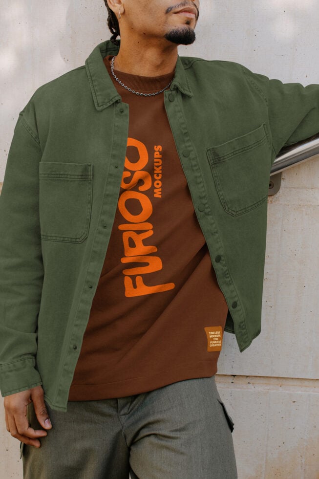 Guy in green overshirt over brown Furioso tee with orange logo, chain necklace visible