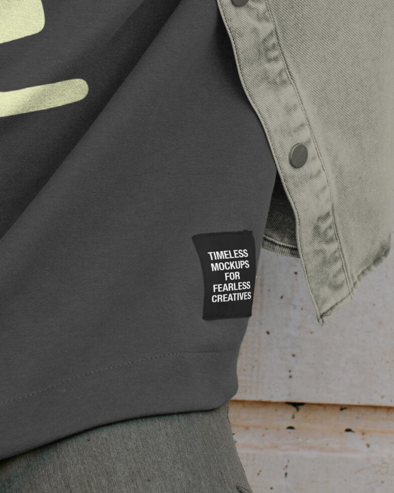 Close-up of black label on gray garment showing white text message