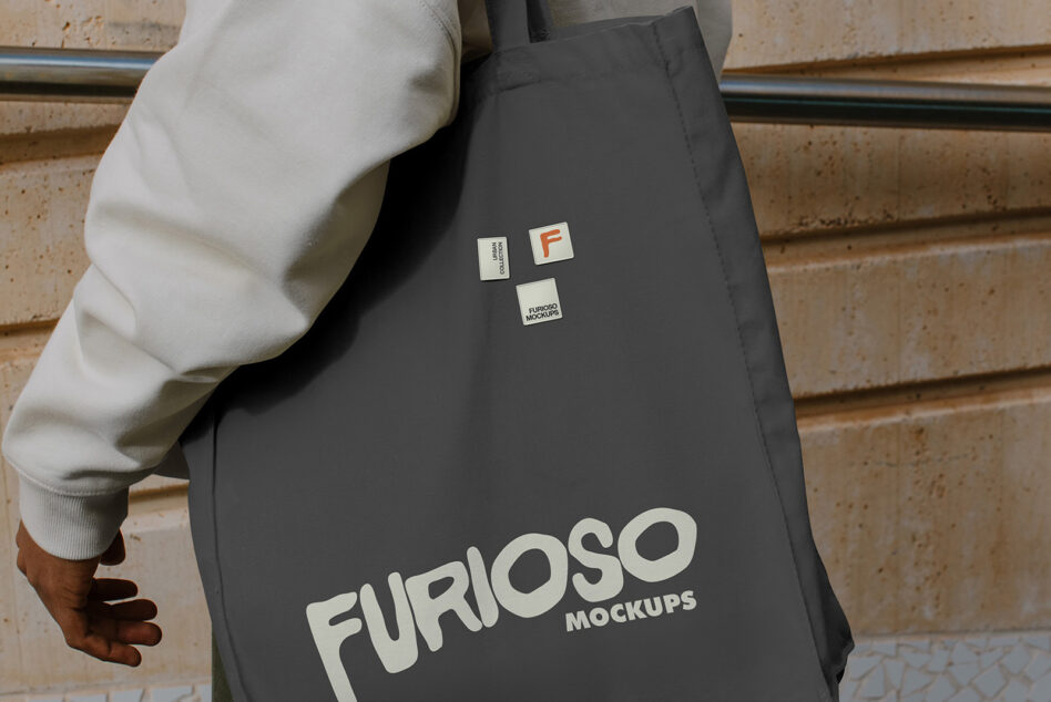 Charcoal tote bag showing cream Furioso Mockups logo with label patch details