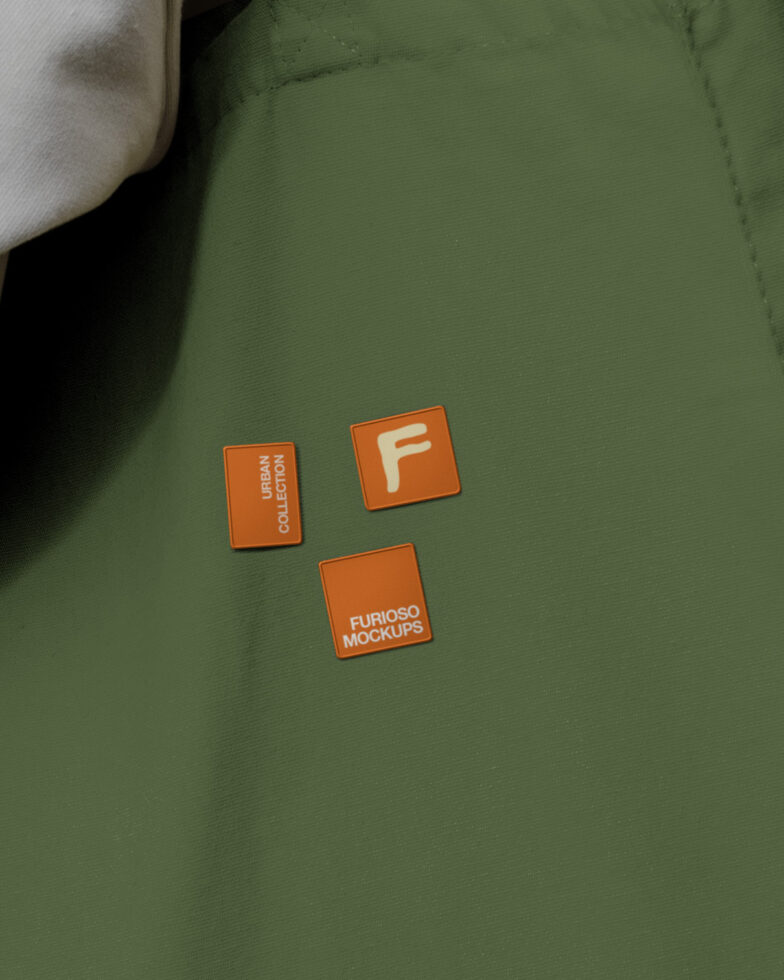 Woven label tags on sage green fabric showing Furioso branding in orange squares
