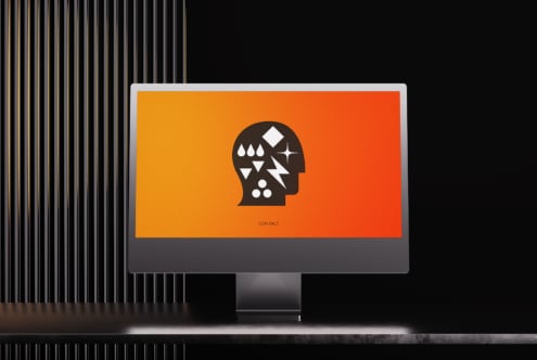 iMac showing vibrant orange gradient background with geometric head icon