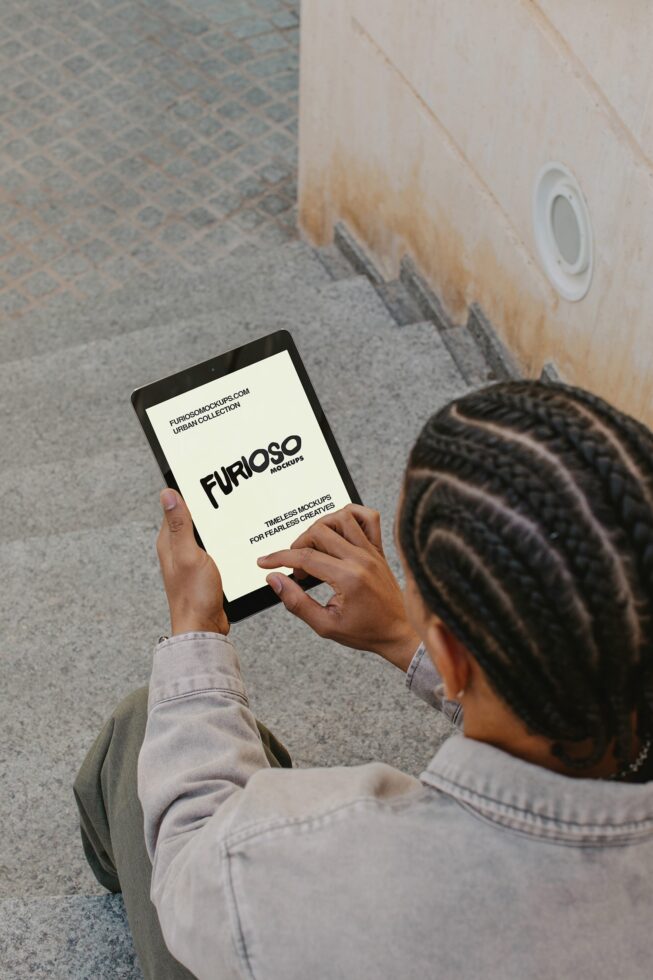 Overhead shot of hands holding tablet with cream screen