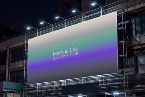 Night shot of illuminated billboard with gradient green to purple displaying Mockup Lab in English