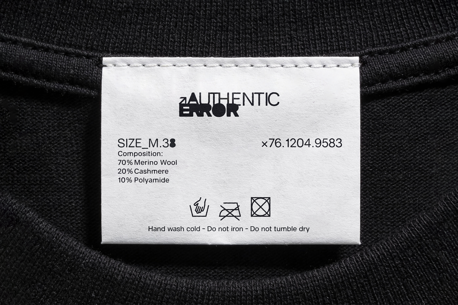 White clothing label with Authentic Error branding, size M.38, fabric composition 70% merino wool, care instructions