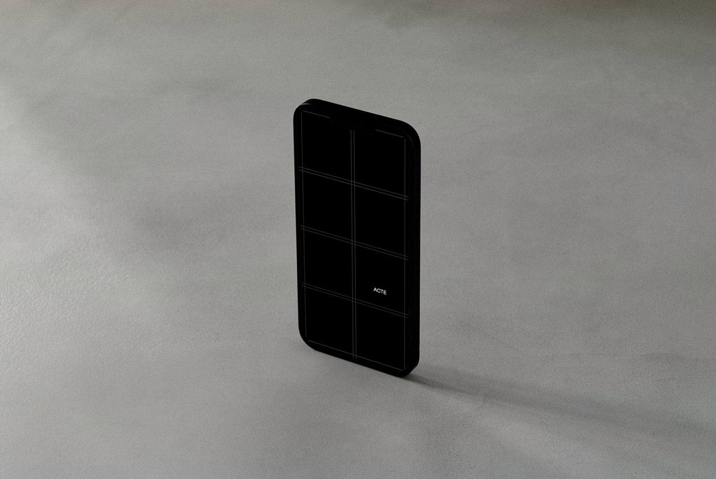 Black phone with dark grid display on light concrete background tilted