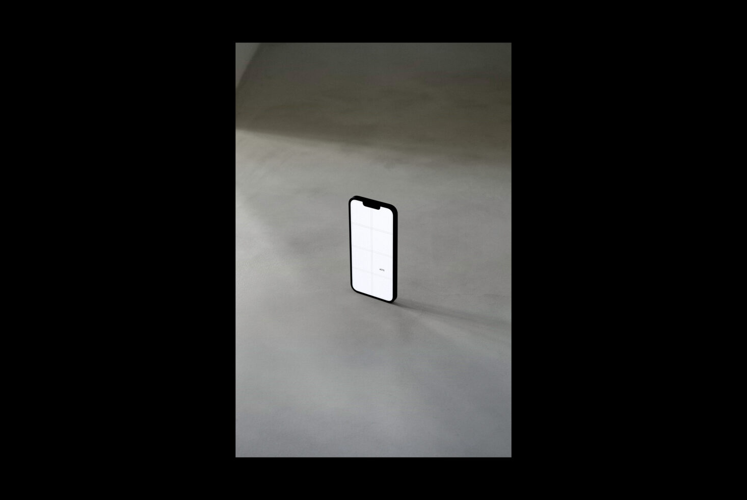 White screen iPhone standing alone on minimal gray concrete floor
