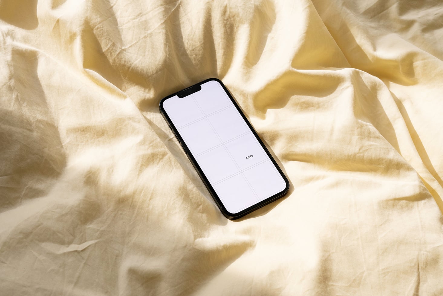 White phone on cream fabric with 6-cell grid mockup layout