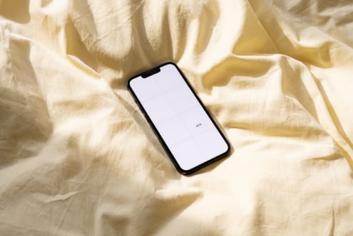 White phone on cream fabric with 6-cell grid mockup layout