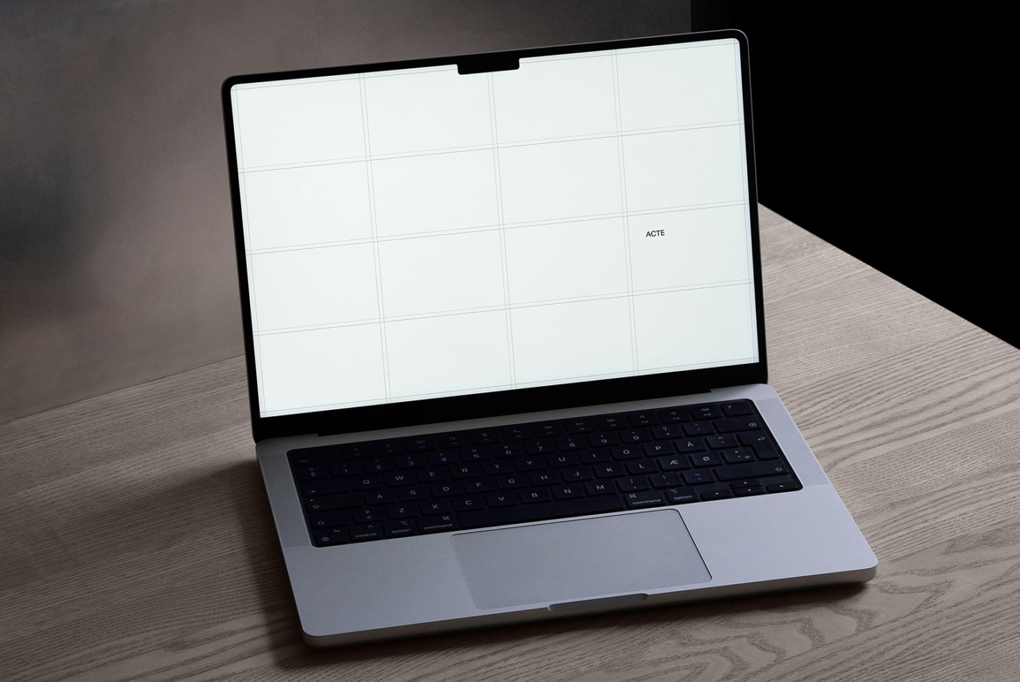 Silver laptop angled open with bright white screen, 4-column grid