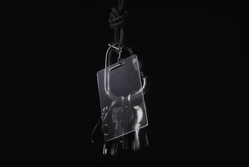 Clear acrylic keychain mockup with braided cord on dark backdrop