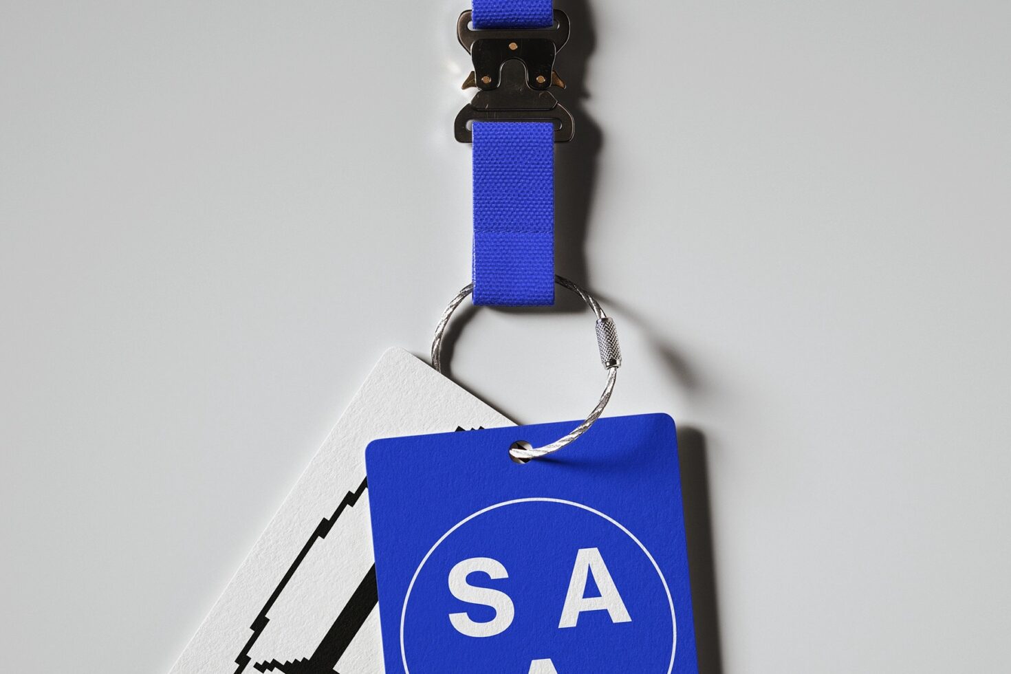 Blue lanyard with black clip holding blue ID badge with SAA logo