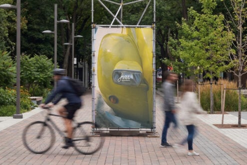 Yellow retro car billboard mockup in public park with blurred pedestrians