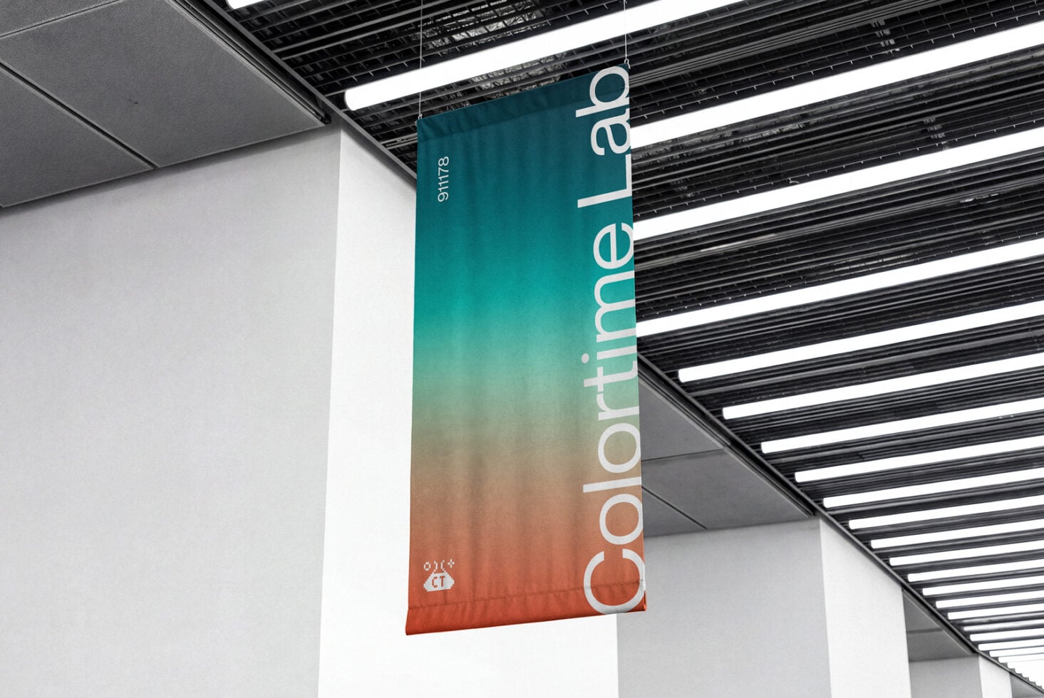 Suspended signage with teal to orange gradient showing vertical typography