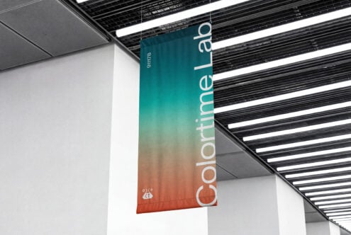 Suspended signage with teal to orange gradient showing vertical typography