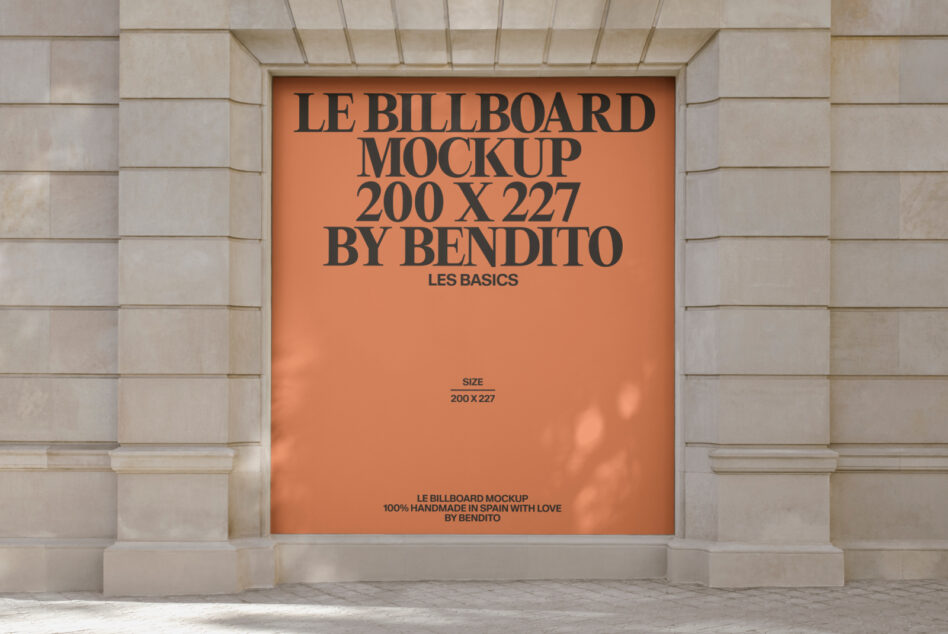 Orange billboard mockup mounted on pale stone building with black serif text