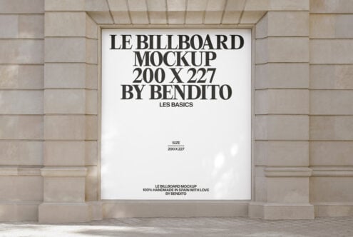 White billboard mockup on stone facade with black typography layout