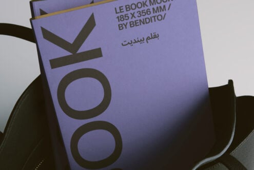 Lavender book cover in black leather tote, close up of branded spine design