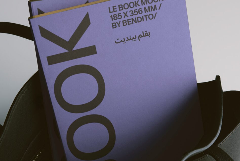 Lavender book cover in black leather tote, close up of branded spine design