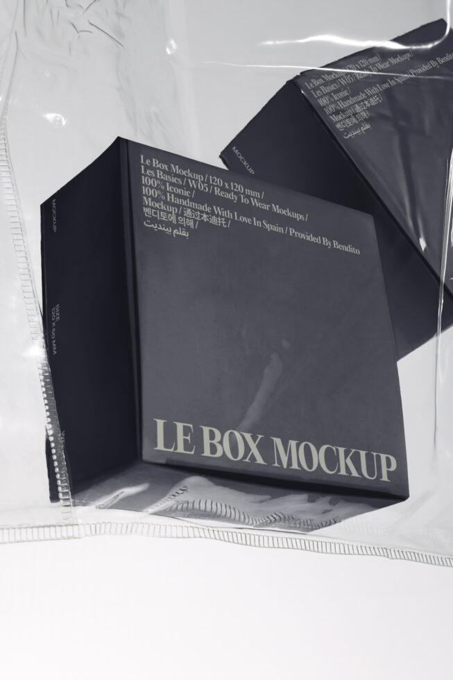 Black box packaging mockup with embossed metallic text partially wrapped in clear plastic