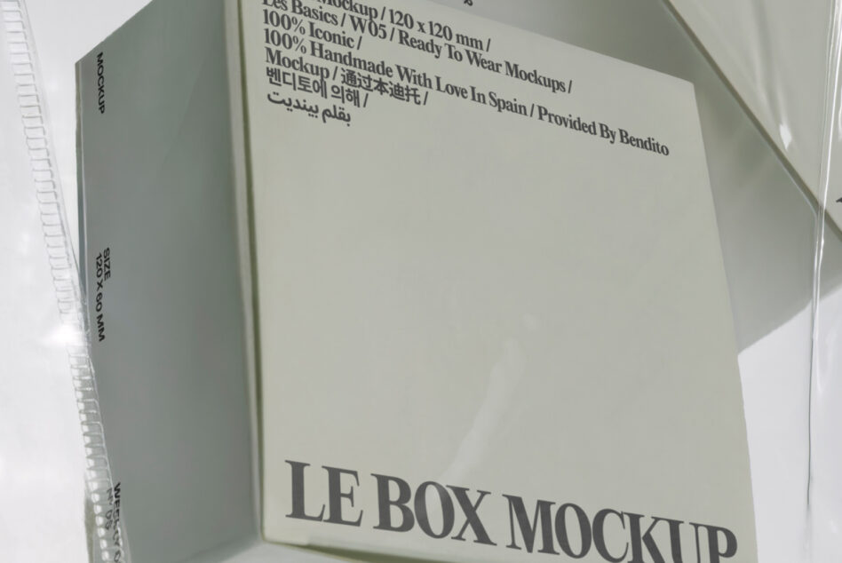 Cream colored box mockup with dark text on angled surface, minimalist setup